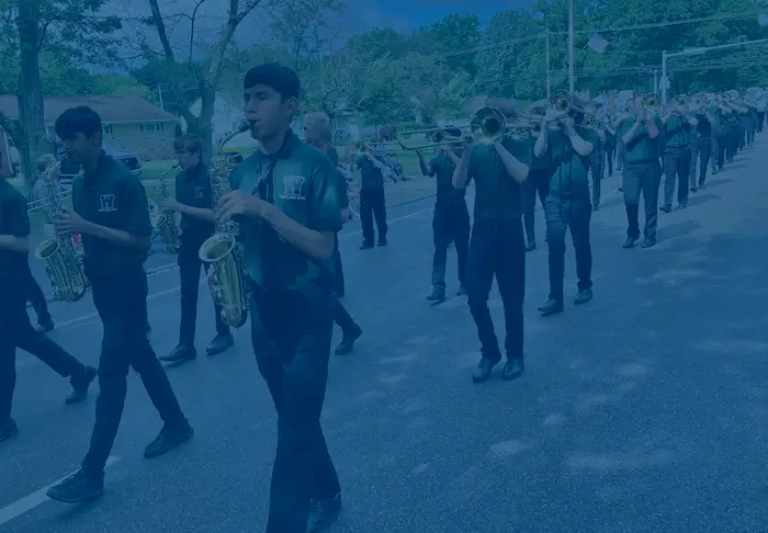 Marching Band Members in Parade with blue overlay and "Events" centered in white